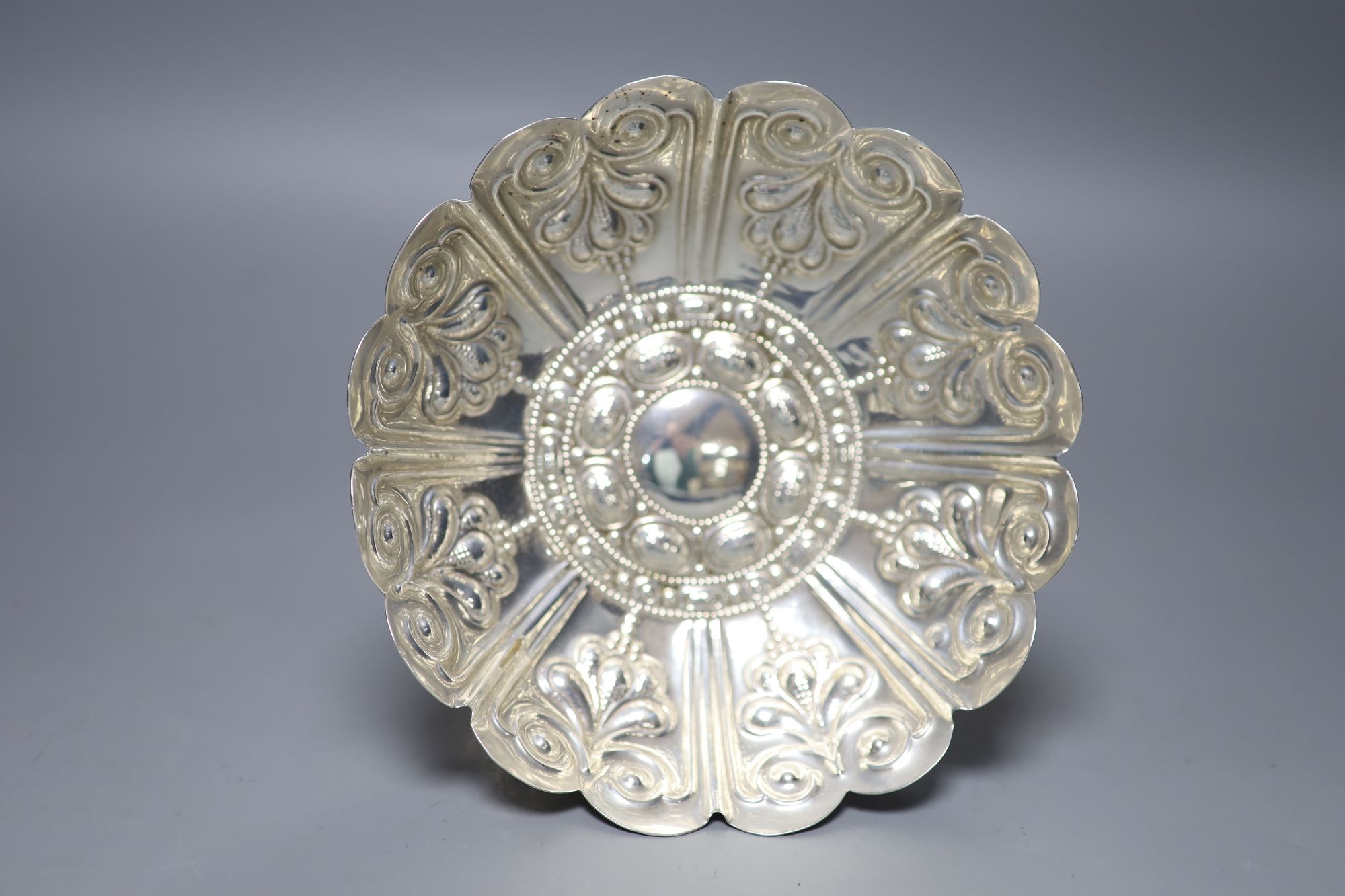 An Edwardian embossed silver circular pedestal dish of lobed form, George Nathan & Ridley Hayes, Chester 1906, 11.78oz.